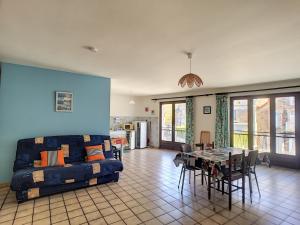 瑞卢维尔莱潘Duplex spacieux à 100m de la plage, 150m des commerces, idéal pour 4 pers, Jullouville - FR-1-361-30的客厅里有一张沙发和一张桌子。