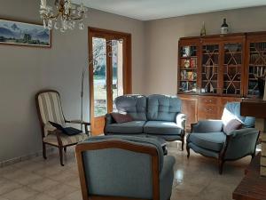 uma sala de estar com um sofá e cadeiras e um lustre em Maison Seignosse, 5 pièces, 8 personnes - FR-1-239-600 em Seignosse