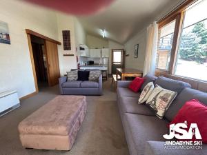 a living room with a couch and a table at Moonbah 2 in Jindabyne
