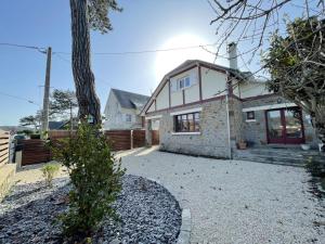 a house with a gravel driveway in front of it at Villa proche Plage et Centre, Jardin Clos, Wifi, Chien possible - FR-1-361-431 in Jullouville-les-Pins