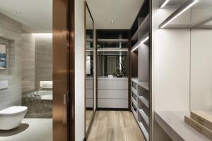 a bathroom with a toilet and a sink at Oakwood Residence Foshan in Foshan