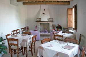 a dining room with two tables and a fireplace at La Spagnera in San Pietro in Vincoli