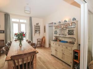 a kitchen with a table and a dining room at Dunholme House in Teignmouth