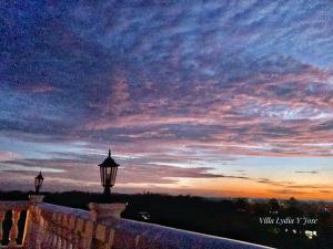 two street lights on a wall at sunset at Villa Lydia y Jose Heritage Hotel in Bayubay Sur