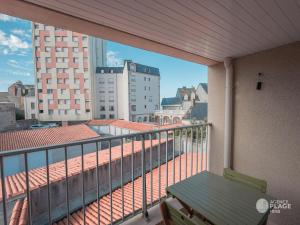 un balcón con un banco verde en un edificio en Appartement Les Sables-d'Olonne, 2 pièces, 4 personnes - FR-1-197-547, en Les Sables-dʼOlonne