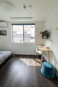 a bedroom with a bed and a desk and a window at 5963 Hotel Higashi Ikebukuro in Tokyo
