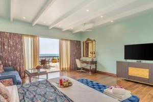 a living room with a couch and a tv at Mayfair On Sea, Morjim Beach, Goa in Morjim