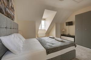 a white bedroom with a bed and a window at Free Parking - Large House - Contractor - Leisure in Peterborough