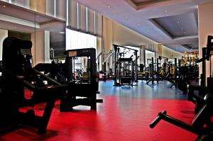 a gym with many treadmills and machines in it at Executives Hotel - Azizia in Riyadh