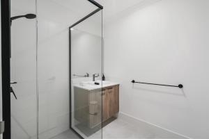 a bathroom with a sink and a glass shower at Villa on Valcross in Dunsborough