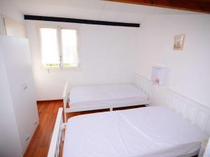 Cette chambre comprend 2 lits et une fenêtre. dans l'établissement Appartement Le Barcarès, 2 pièces, 4 personnes - FR-1-431-181, au Barcarès