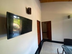 a flat screen tv hanging on a wall at The Kingslayer Resort in Negombo