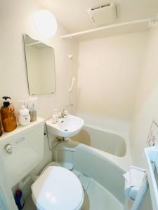 ein Badezimmer mit einem WC, einem Waschbecken und einer Badewanne in der Unterkunft Namba Tsutenkaku High Class Villa in Osaka
