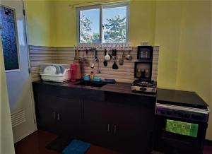 a kitchen with a sink and a counter top at Lovely Casa 