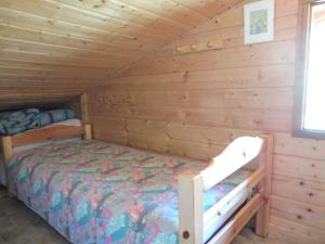a bedroom with a bed in a log cabin at Appartement duplex cosy à Crest-Voland, 6 pers, proche pistes et garage inclus - FR-1-595-72 in Crest-Voland