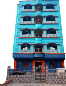 a tall blue building with stairs in front of it at Goroomgo Muskan Guest House Digha in Digha