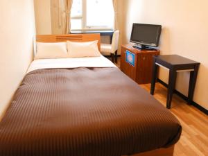 Postel nebo postele na pokoji v ubytování HOTEL LiVEMAX BUDGET Kawasaki Ekimae