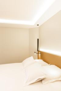 a bed in a room with a large window at Suite Romanée 6 personnes vue Cathédrale 2 Places de parking in Dijon