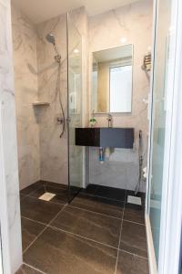 a bathroom with a shower and a sink at ibis budget Singapore Gold in Singapore