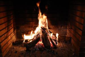 a fire in a brick oven with flames at Casa La Buganvilla 1 Aracena in Aracena