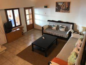 a living room with a couch and a tv at Villa Aktan in Kas