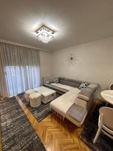 a living room with a couch and a table at Central Luxury Suites in Bijeljina
