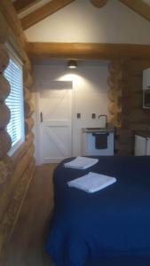 a room with two beds in a log cabin at The Cabin in Twizel