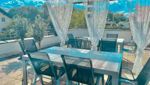 a table and chairs on a balcony with a view at LUXURY STAY SALZBURG City in Salzburg