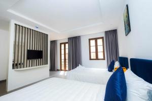 Postel nebo postele na pokoji v ubytování Rose Hotel Phú Quốc
