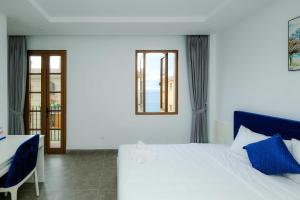 Postel nebo postele na pokoji v ubytování Rose Hotel Phú Quốc