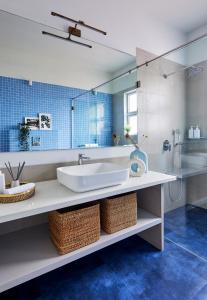 a bathroom with a sink and a mirror at SaffronStays Kaia Waters by Kosha Villas, Pawna - Greek style villa with panoramic view of Pawna lake in Kolvan