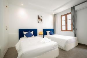 Postel nebo postele na pokoji v ubytování Rose Hotel Phú Quốc