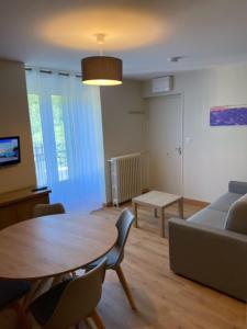 a living room with a table and a couch at Maison Ardiden in Luz-Saint-Sauveur