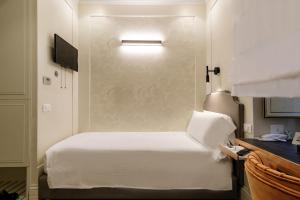 Postel nebo postele na pokoji v ubytování Hotel Smeraldo