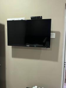 a flat screen tv hanging on a wall at Hotel Sagittario in Ipoh