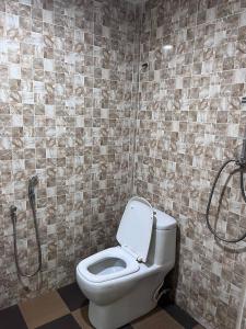 a bathroom with a toilet and a shower at Hotel Sagittario in Ipoh
