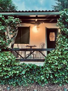 a patio with a table and chairs on a porch at Mika’s Garden in Bled