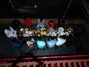 a group of people sitting around a table with plates at New Summer Capital in Shimla +43 photos