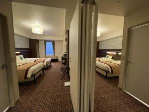 Ένα ή περισσότερα κρεβάτια σε δωμάτιο στο Hotel Monterey Fukuoka