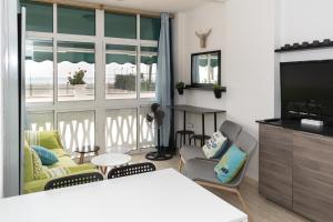 a living room with a couch and a television at Lider, 44-E (Planta Baja) in Cullera
