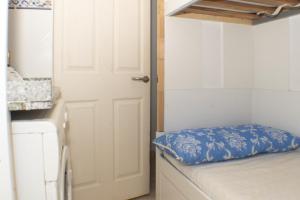 a door leading into a small room with a bed at Lider, 44-E (Planta Baja) in Cullera