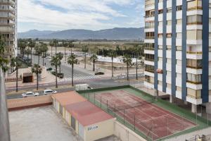 a building with a tennis court on the roof of it at Lider, 44-E (Planta Baja) in Cullera