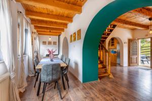 a dining room with a table and chairs and an archway at Holiday home Palo santo in Gospić