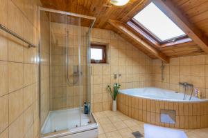 a large bathroom with a tub and a shower at Holiday home Palo santo in Gospić