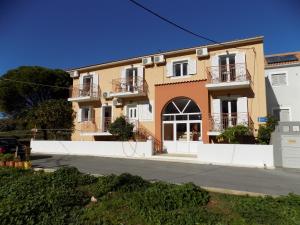 a house on the side of a street at Afrodite Spacious Apartments! in Agia Effimia