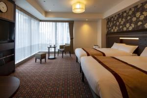 Ένα ή περισσότερα κρεβάτια σε δωμάτιο στο Hotel Monterey Fukuoka