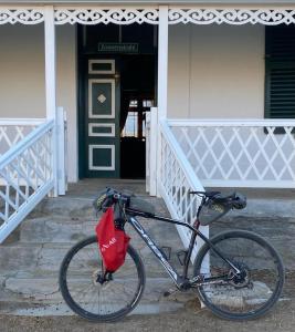 a bike parked in front of a building at Zonnenstrahl Selfcatering Holiday home & Caravan Park in Nieu-Bethesda