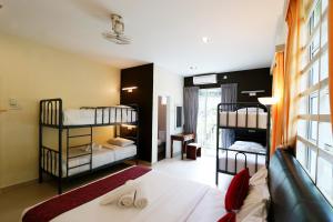 a bedroom with two bunk beds and a couch at Golden Lodge in Tanah Rata