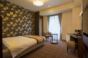 Ένα ή περισσότερα κρεβάτια σε δωμάτιο στο Hotel Monterey Fukuoka