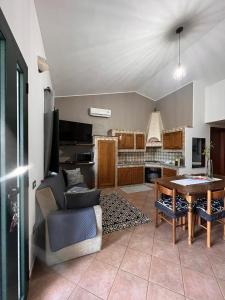 a living room with a couch and a table at CASA DEPAU in Tertenìa